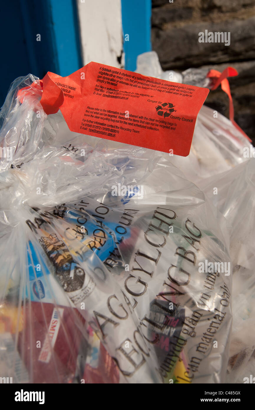 Plastic bags full of items for recycling tagged as containing