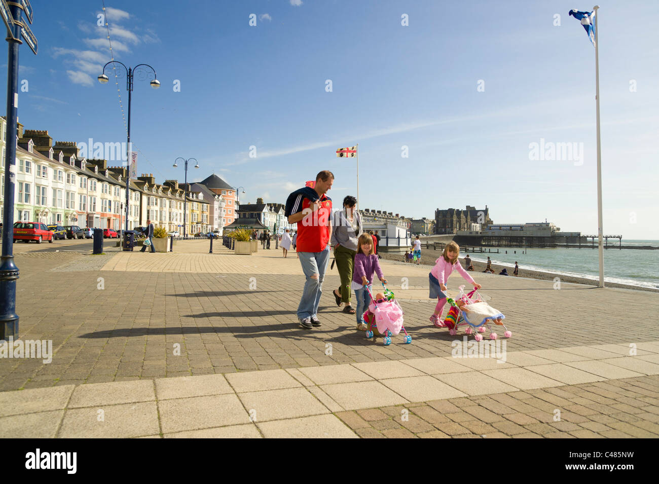 Summer afternoon, a family walking on Aberystwyth promenade, Wales UK Stock Photo
