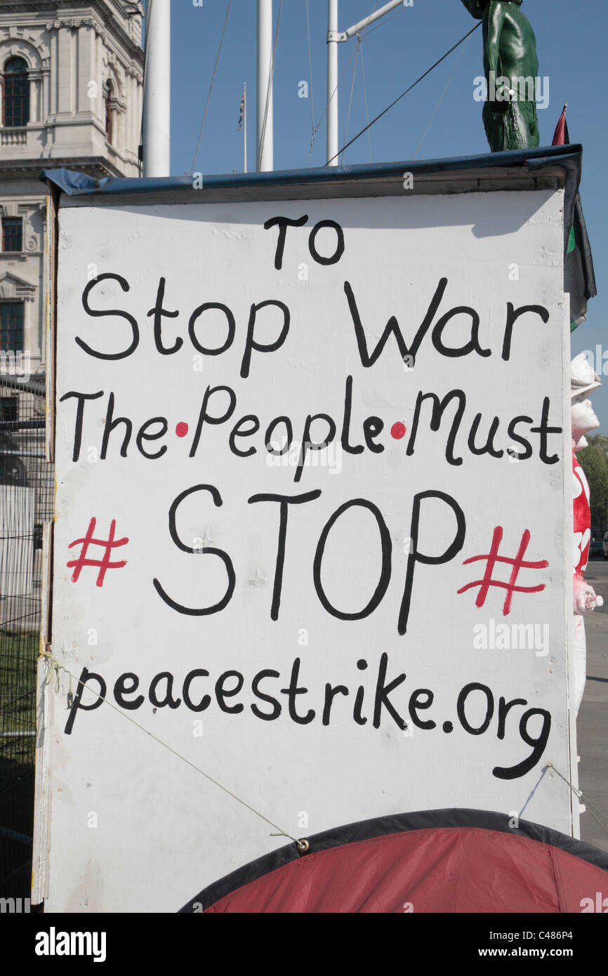 An anti-war protest banner in Parliament Square outside the Houses of Parliament in Westminster, London, UK. Stock Photo