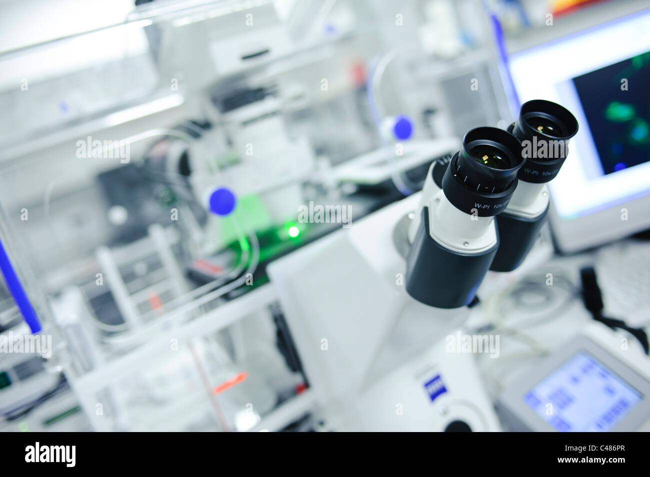 Close up of microscope in science lab brightly lit Stock Photo