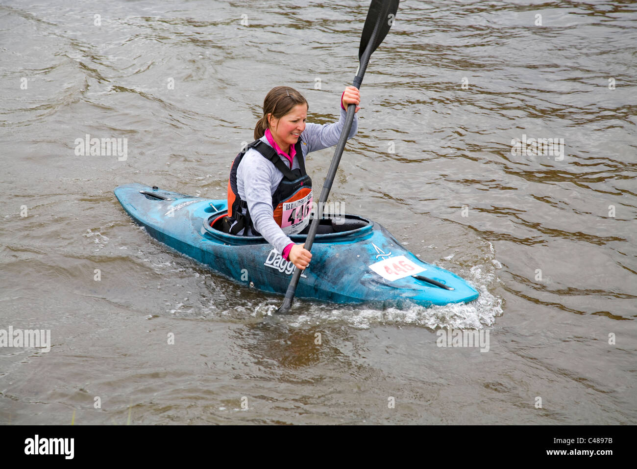Middle school girl paddling a kayak during the Pole, Pedal, Paddle race