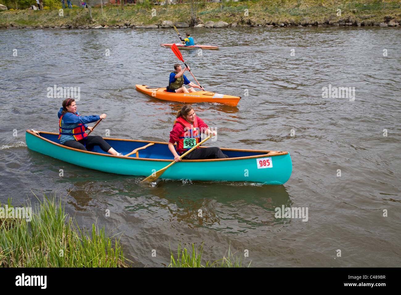 Two high school girls canoeing during the Pole, Pedal, Paddle race in Bend, Oregon Stock Photo
