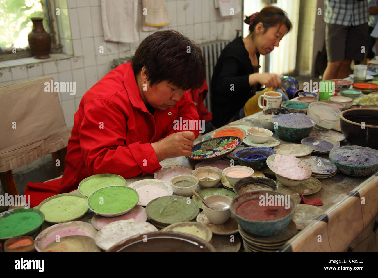 Woman works in a Cloisonne Ware factory Beijing, China Stock Photo