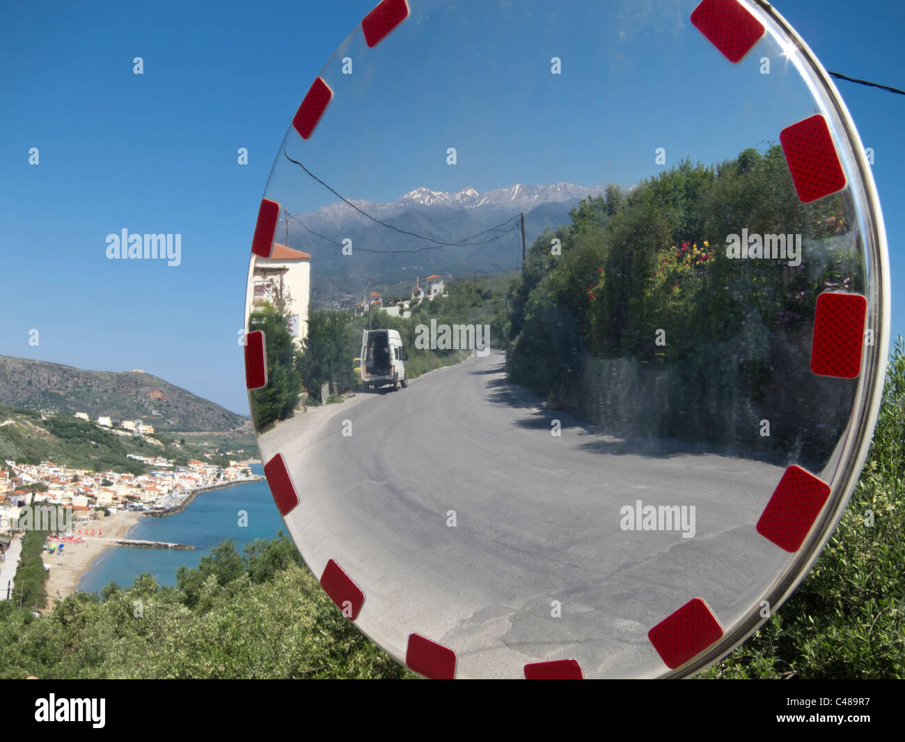 View in a road traffic safety mirror on Almirida, a small Village on Crete, Greece. Stock Photo