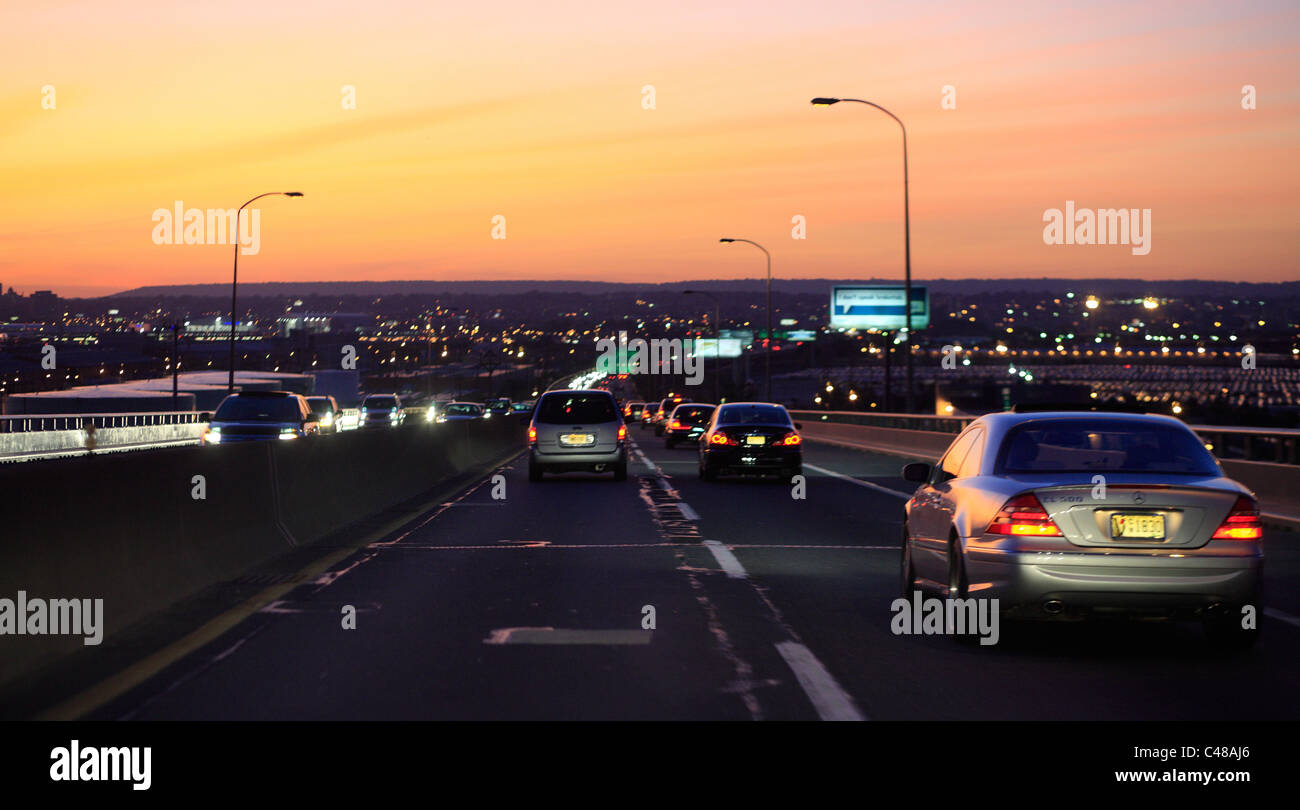 Cars driving on a highway at sunset, Jersey City, USA Stock Photo