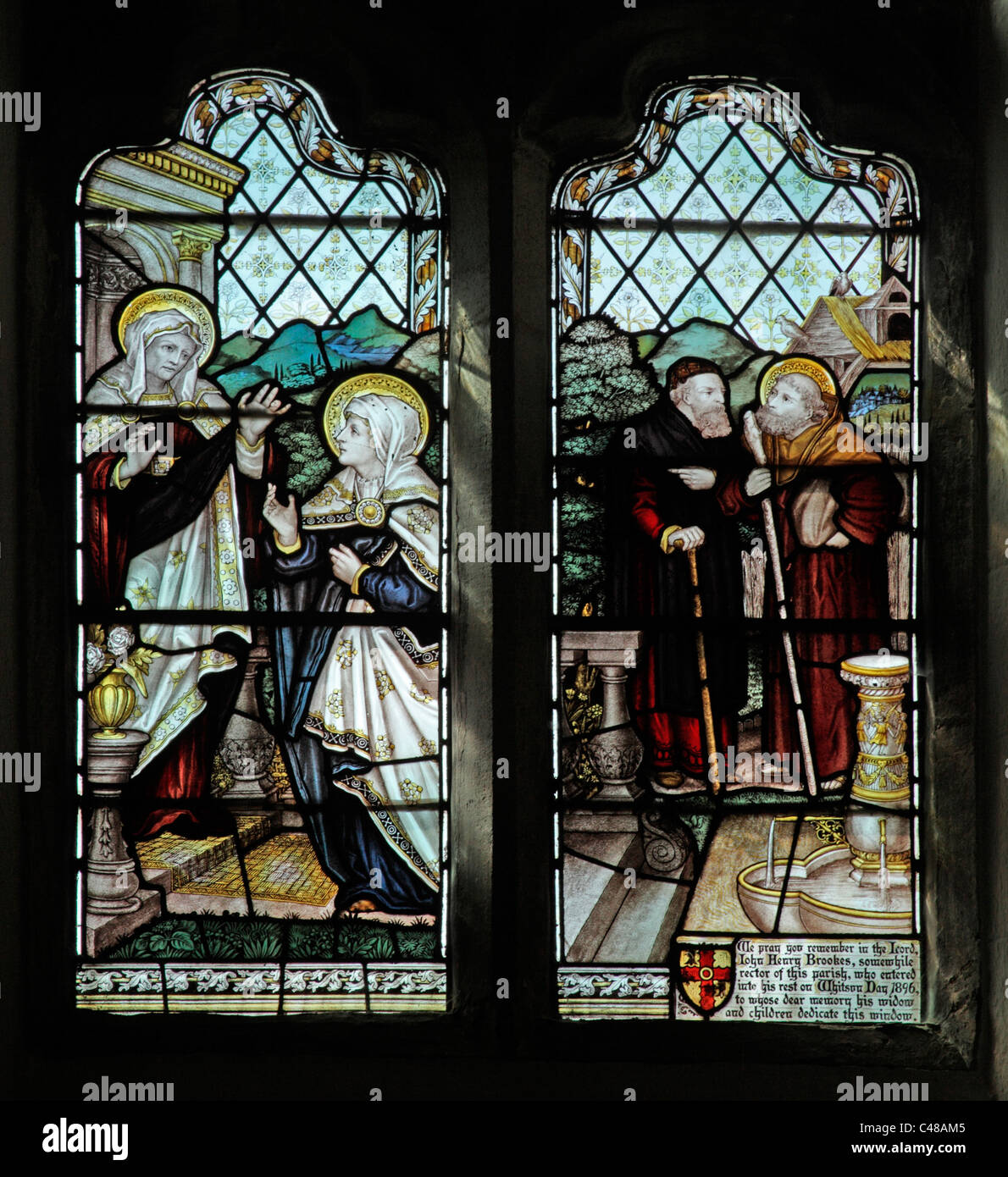 A stained glass window by The Kempe Studios depicting the Visitation, Church of St Peter and St Paul, Steeple Aston, Oxfordshire Stock Photo