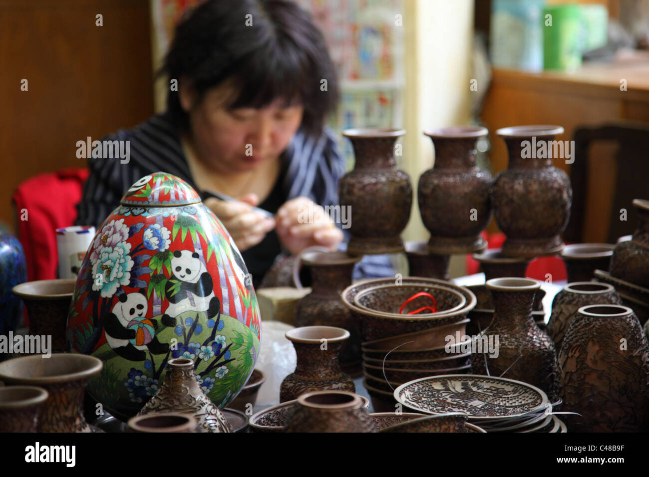 Woman works in a Cloisonne Ware factory Beijing, China Stock Photo