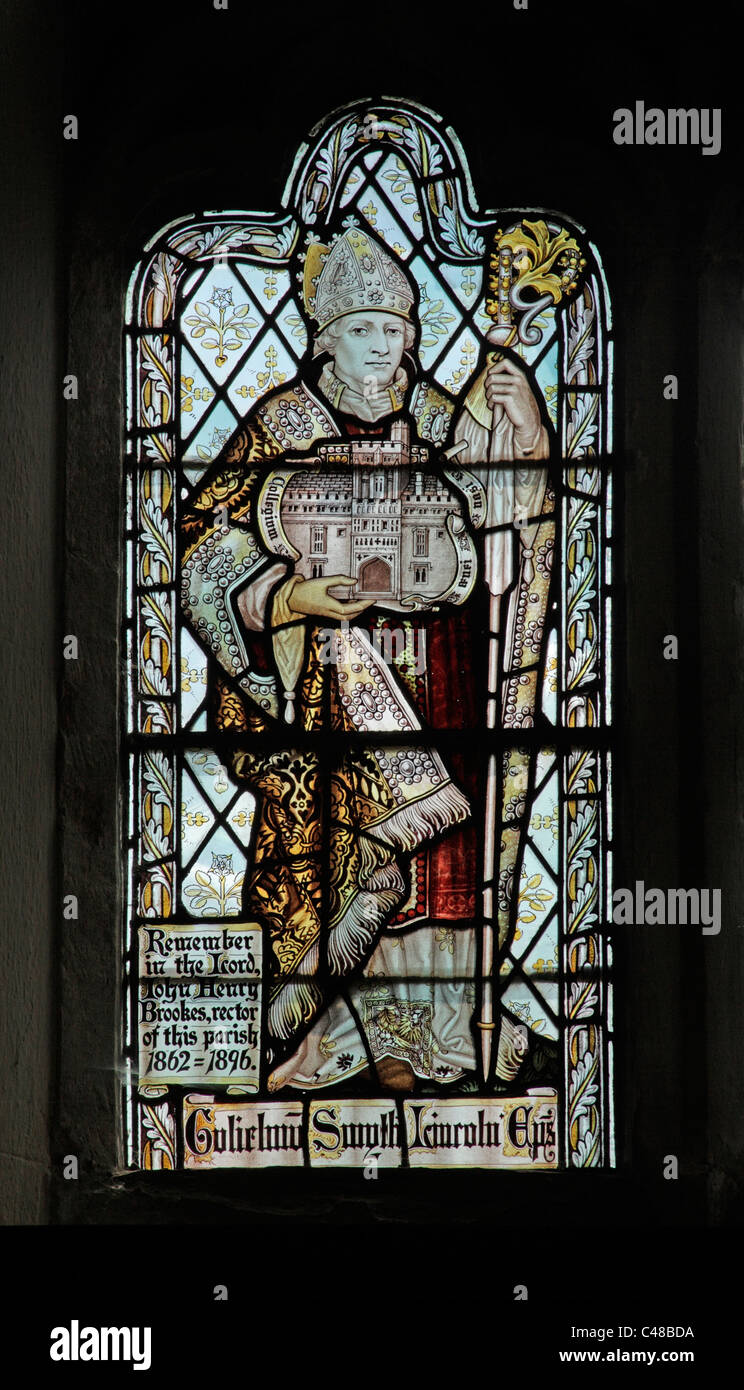 A stained glass window by The Kempe Studios depicting William Smythe Bishop of Lincoln, founder of Brazennose College, Oxford Stock Photo