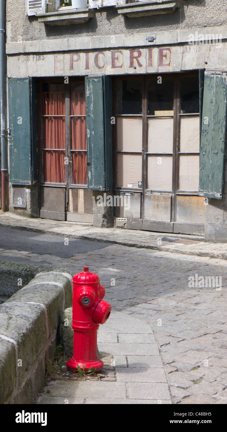 Red fire hydrant on cobbled street, Aubusson, Cruese, France Stock Photo