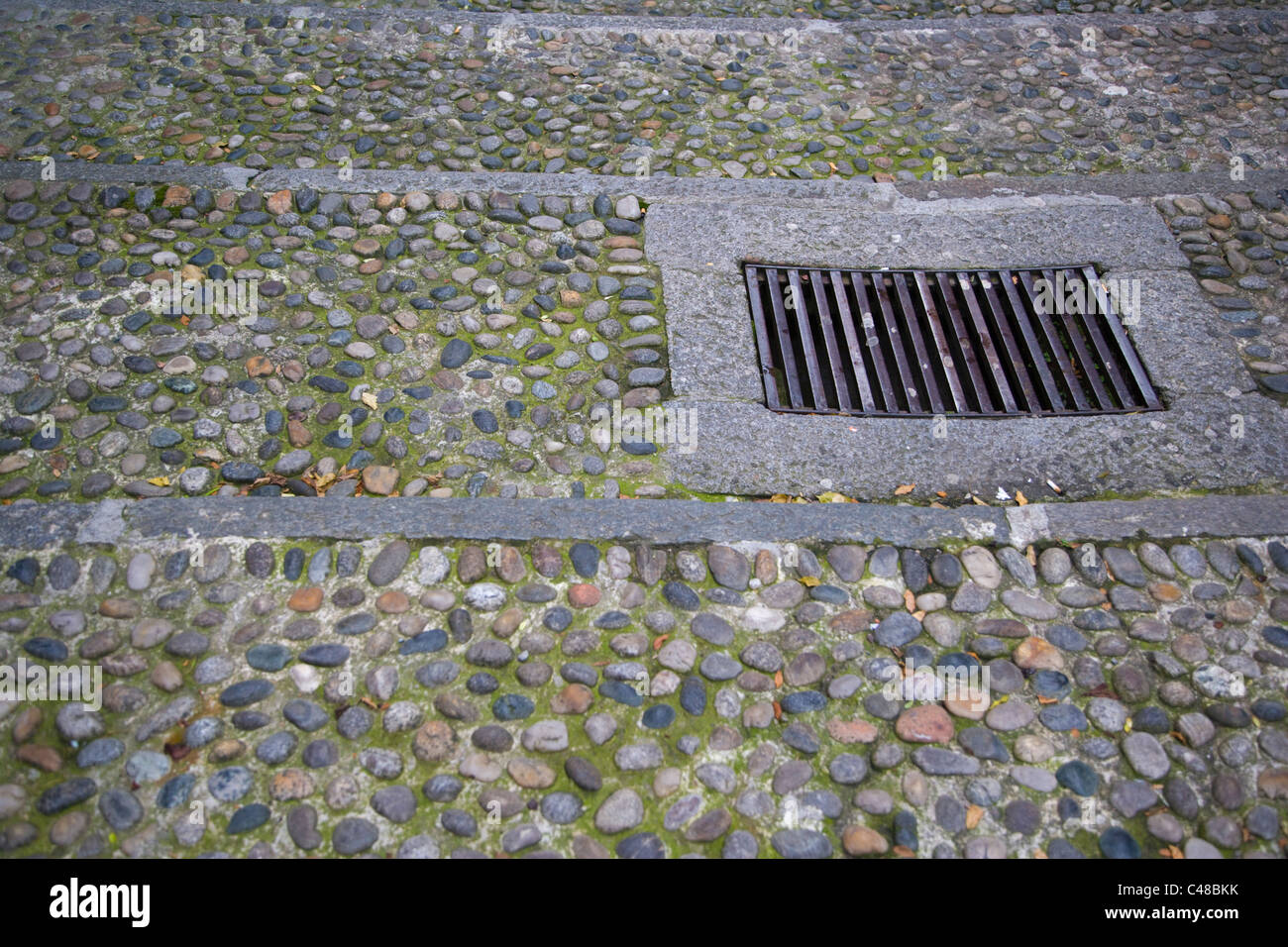 Cobble stone pavement with drain. Bellagio on Lake Como. Lombardy. Italy. Stock Photo