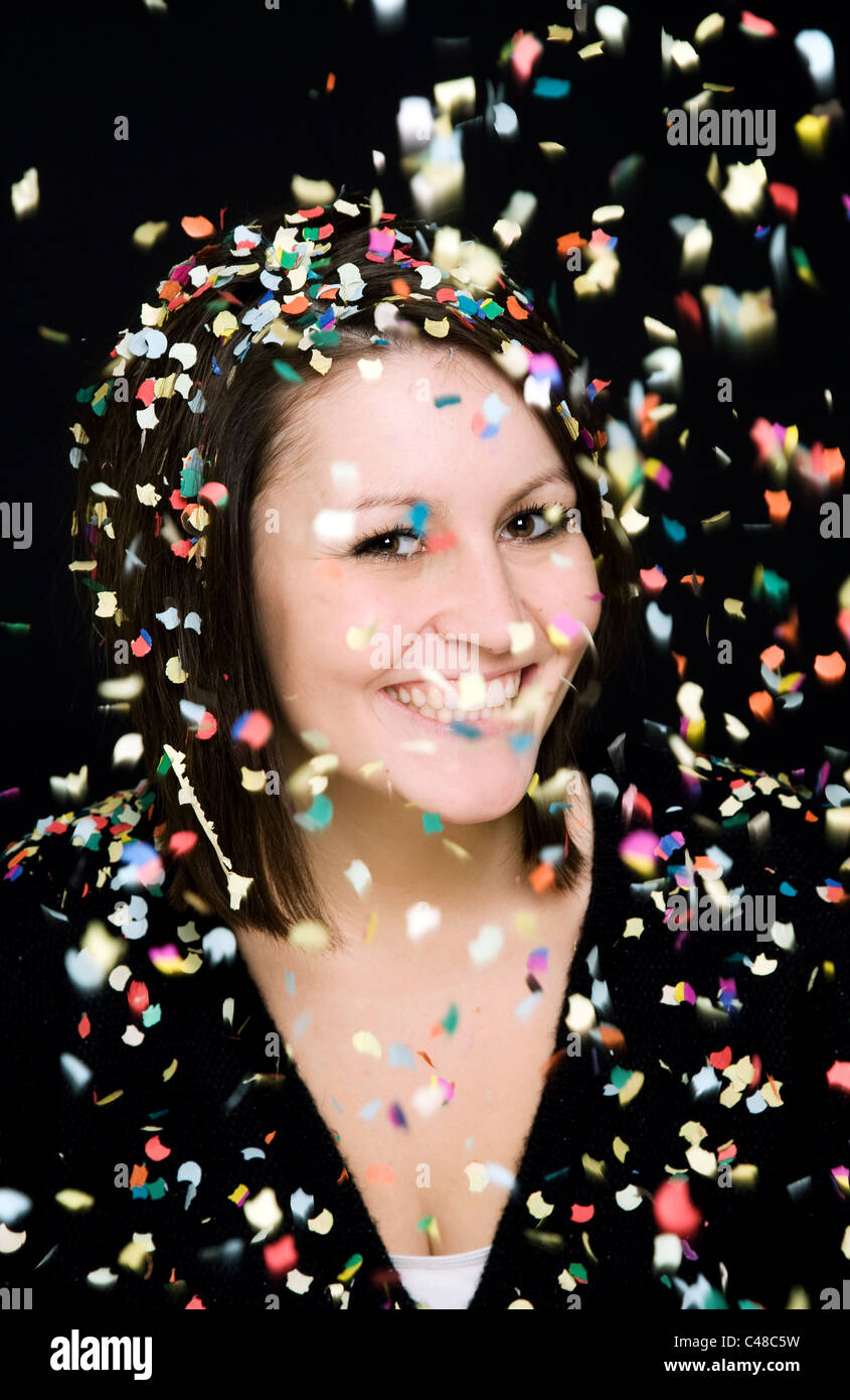 A woman smiling in a rain of confetti Stock Photo Alamy