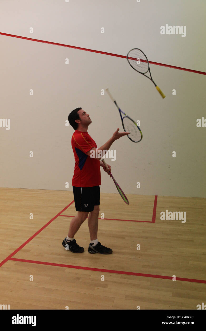 Squash player juggling squash rackets Stock Photo Alamy