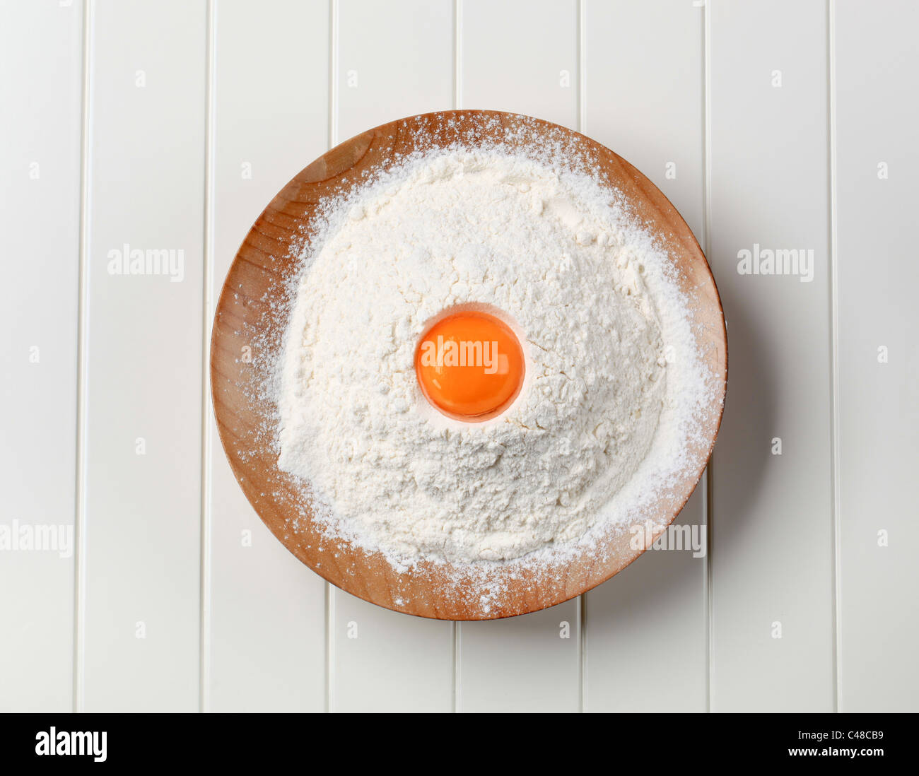 Fresh egg yolk and heap of flour Stock Photo Alamy