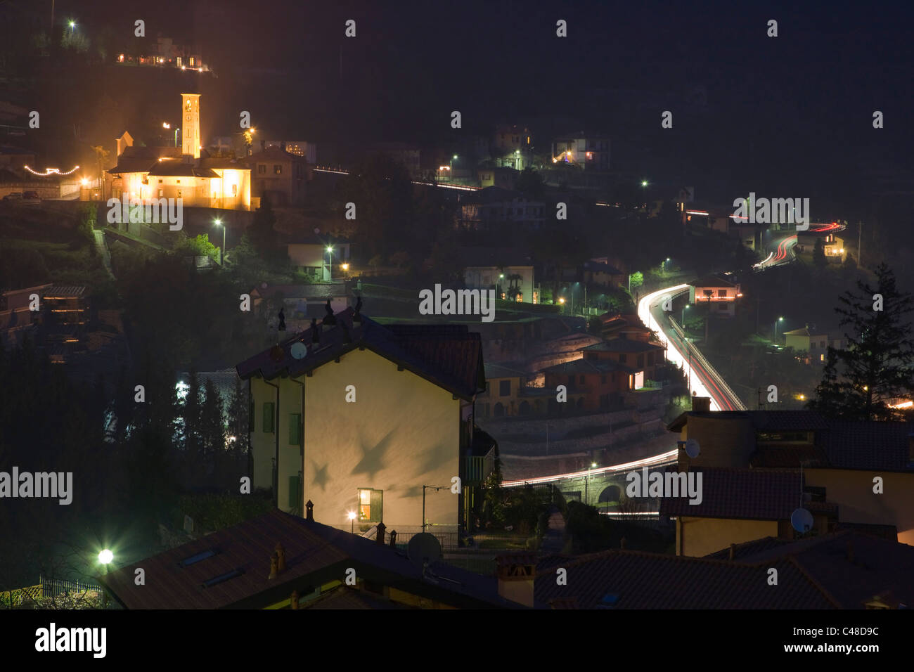 Twilight Argegno with Chiesa di S. Sisinnio from Via Schignano at Argegno on Lake Como. Lombardy. Italy. Stock Photo