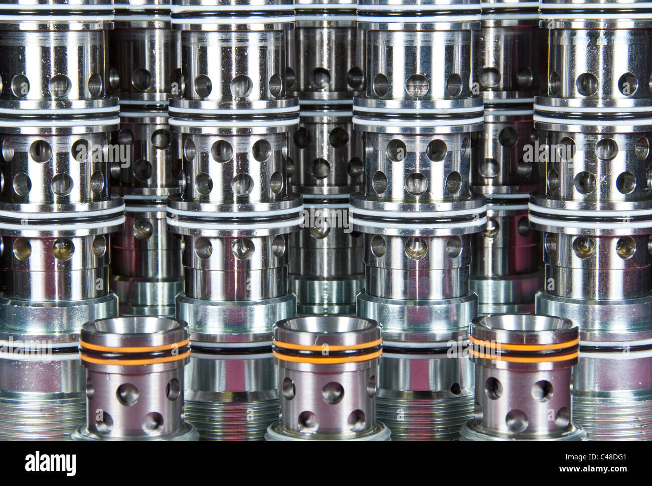 Multiple Hydraulic Cartridge Valves covered in oil on a red shop cloth