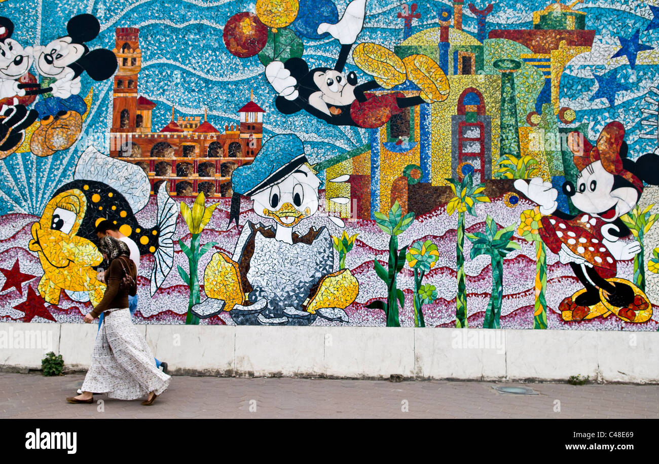 A Couple Walking By A Colorful Disney Painted Wall In Alexandria Egypt Stock Photo Alamy