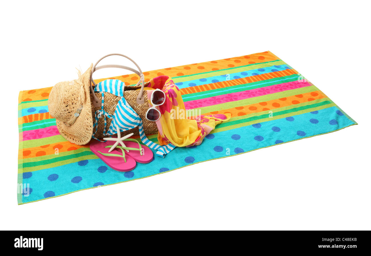 Beach accessories with swimming suit,straw hat,sun glasses,shawl and flip flops on white background. Stock Photo