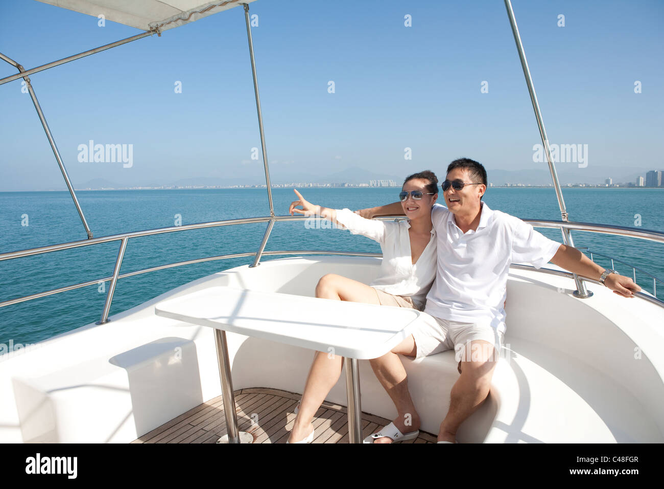 Happy Couple Relaxing on a Yacht Stock Photo