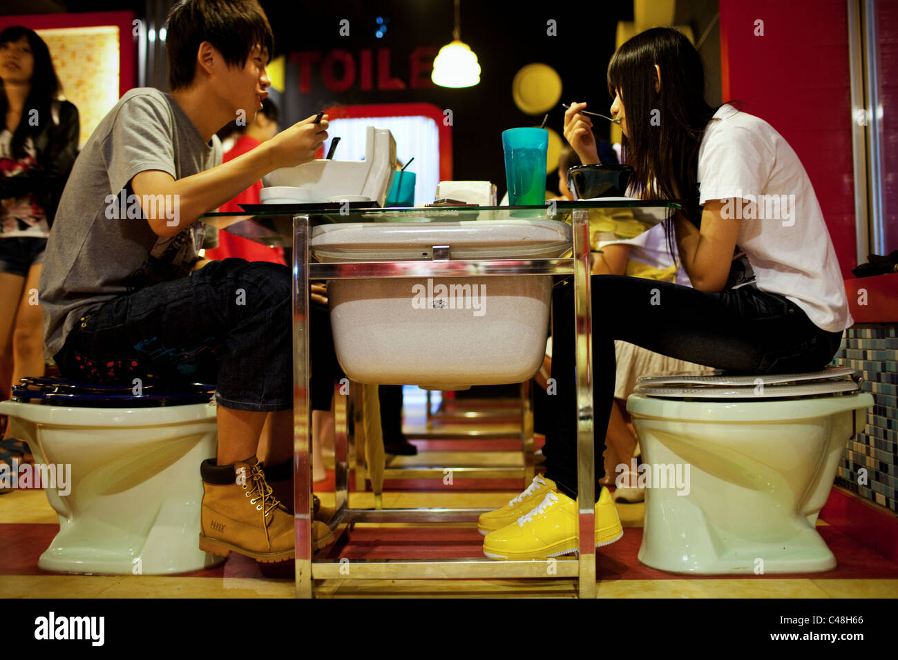 A young couple enjoys dinner at Modern Toilet Restaurant in Ximending, Taipei, Taiwan, October 24, 2010. Stock Photo