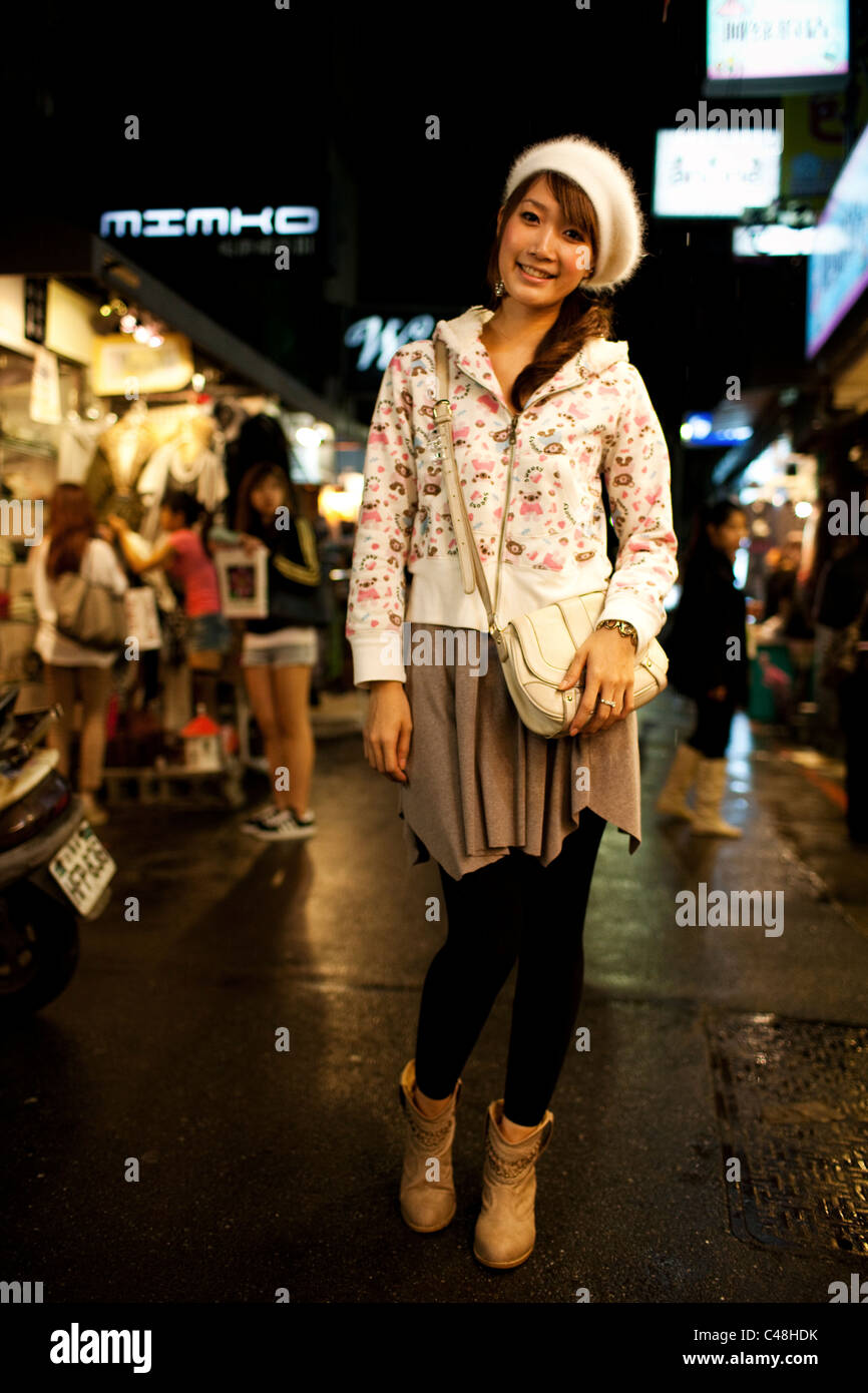 Portrait of a young woman by her clothing stall at the Shida Road Night Market, Taipei, Taiwan, November 5, 2010. Stock Photo