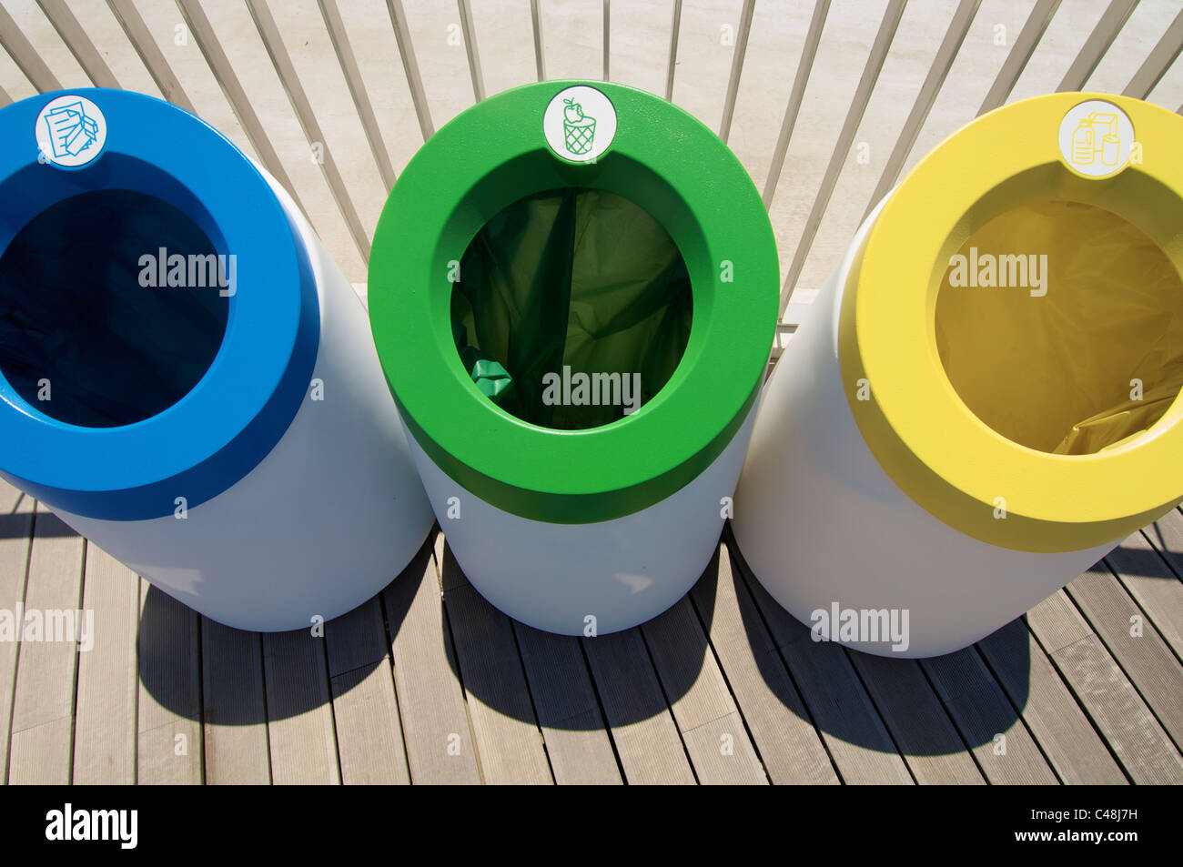 three bins for recycling paper, glass and organic materials Stock Photo