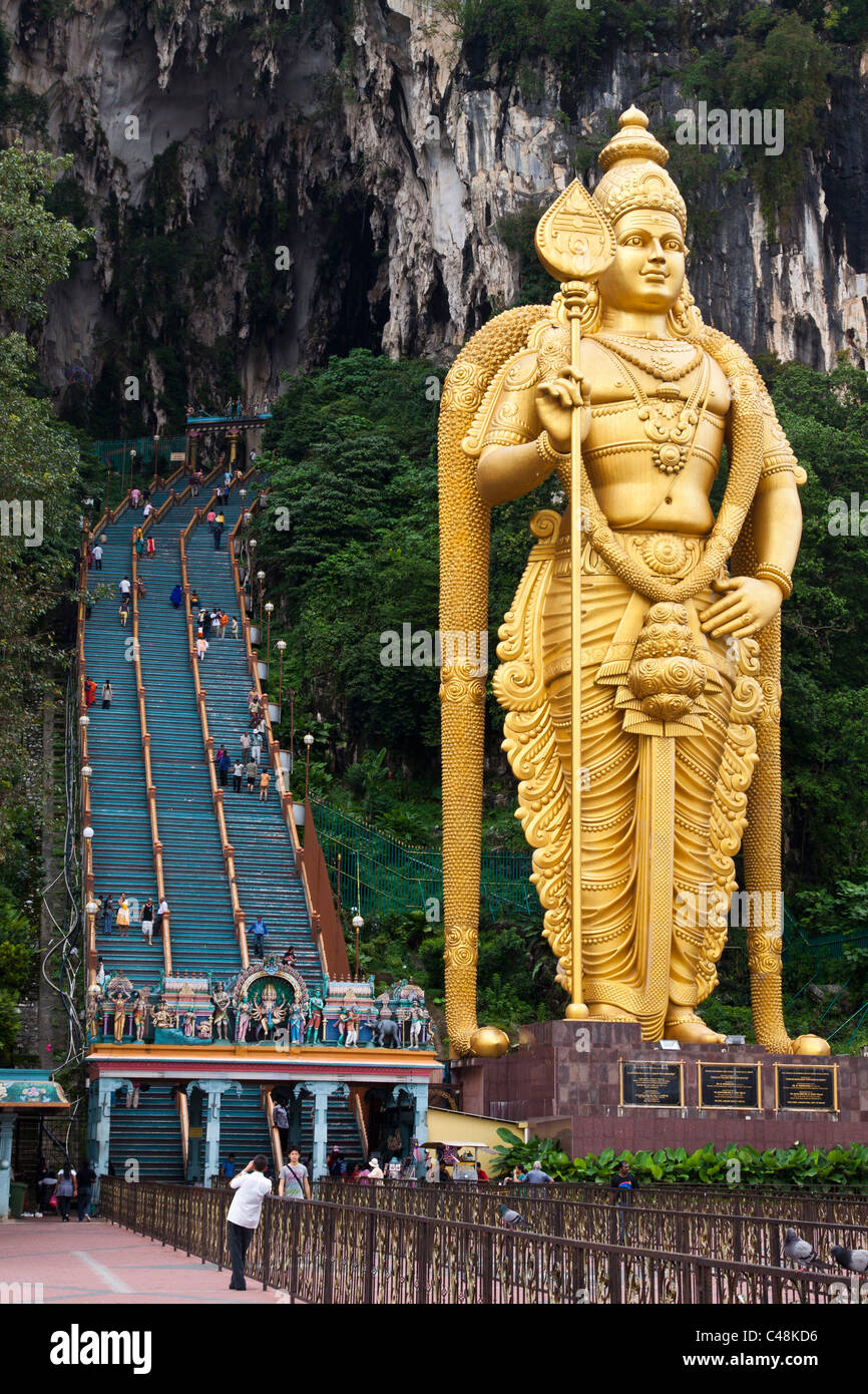 Golden statue of Lord Murugan at the entrance to Batu Caves. Kuala Lumpur – Malaysia. Photo was taken 25 September 2010. Stock Photo