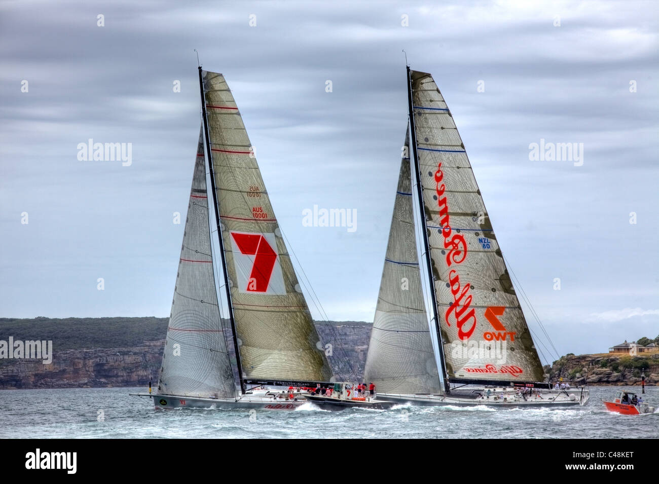 The super maxi yachts Wild Oats racing against Alfa Romeo during The  SOLAS Big Boat challenge 2009, Sydney Harbour, Australia. Stock Photo