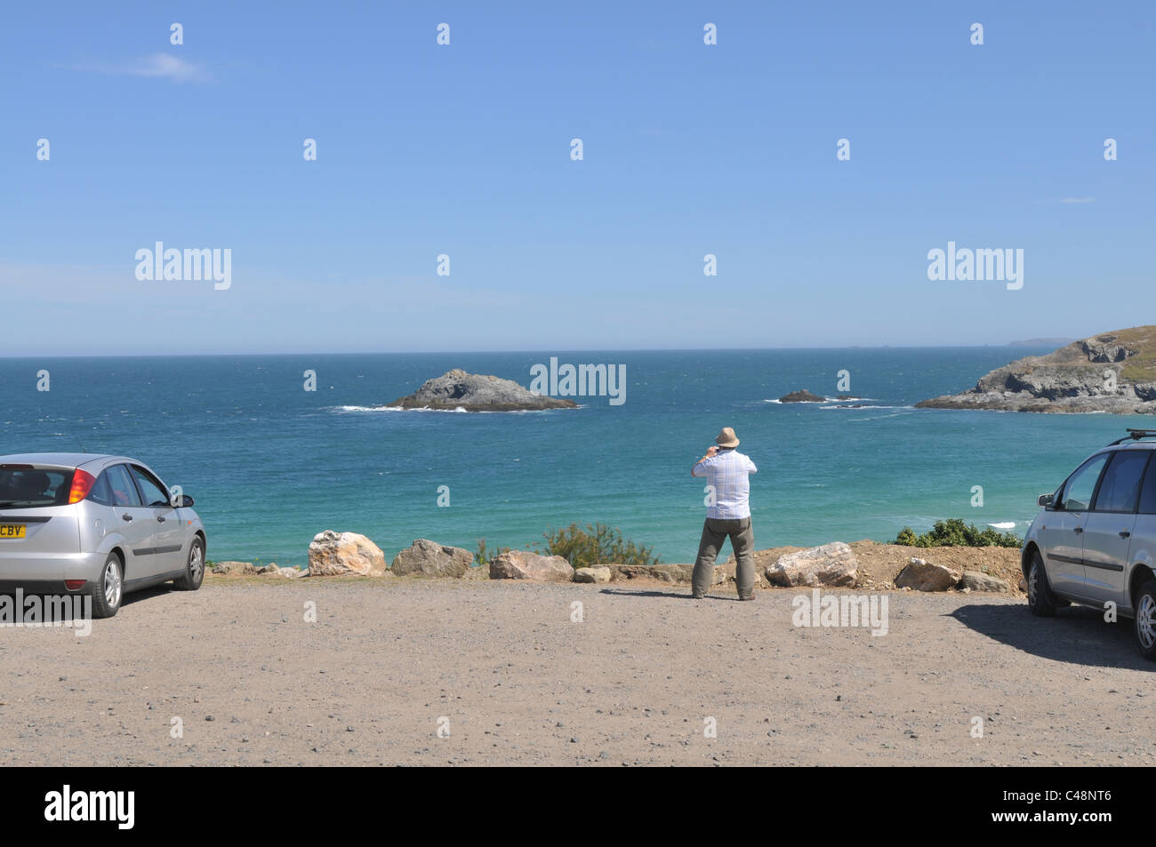 A tourist takes a photograph at West Pentire, Crantock, Cornwall Stock Photo