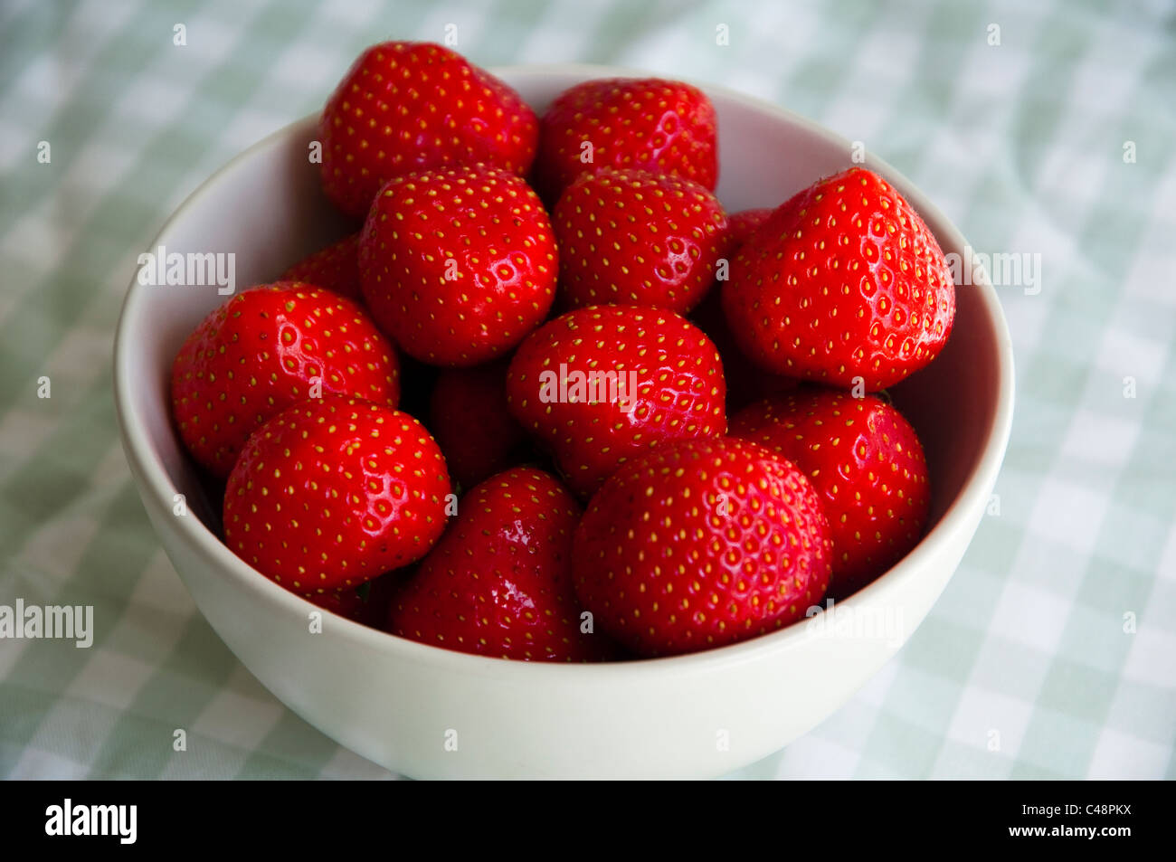 Fresh Strawberries in a white bowl. Stock Photo