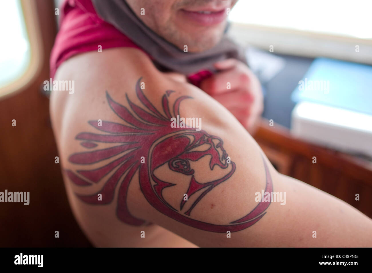 Tribal diver displays his tribal tattoo onboard a fishing vessel  in Puget Sound near Suquamish, Washington Stock Photo