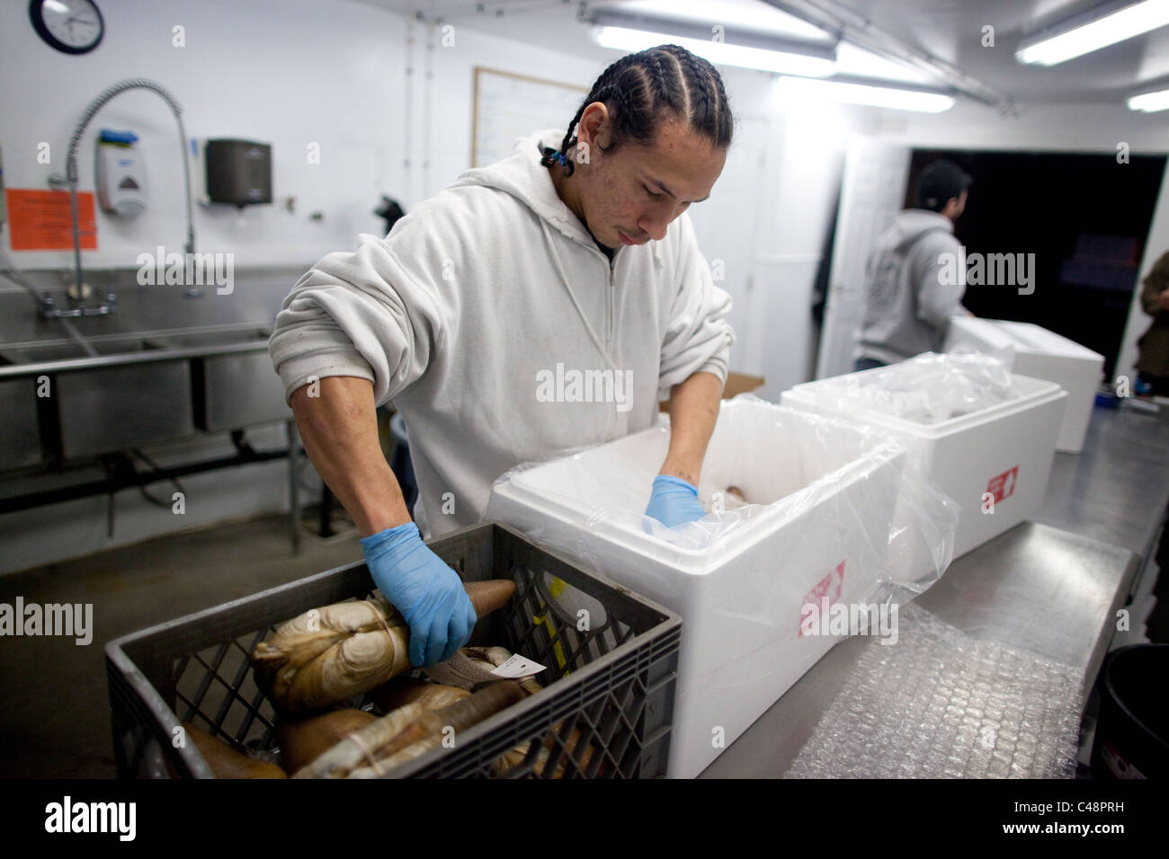 Tribal plant worker, with the Suquamish Seafood Corp packs harvested