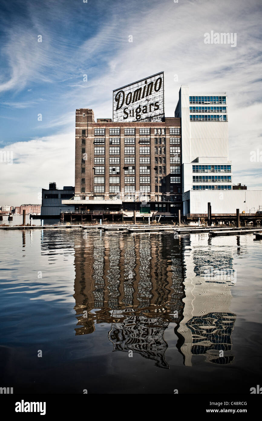 Dominos Sugar factory with its reflection on the harbor water. Stock Photo