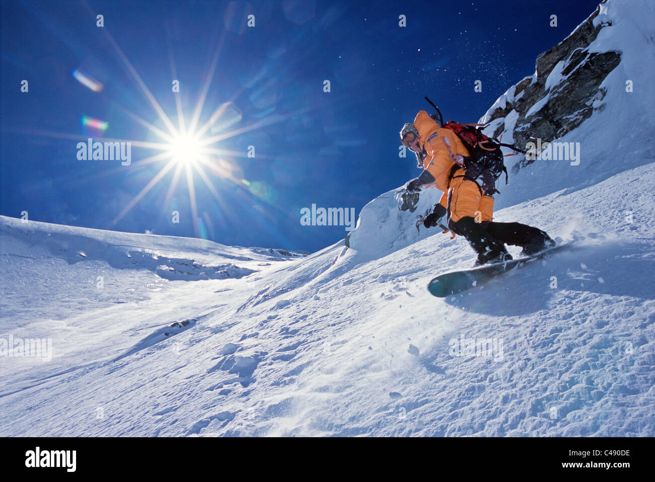 A man snowboards down the North Face of Mount Everest with a sun flare in  background Stock Photo - Alamy