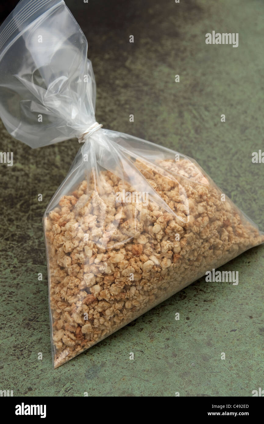 Granola, a breakfast food and snack food of oats, nuts & maple syrup in a plastic bag. Stock Photo