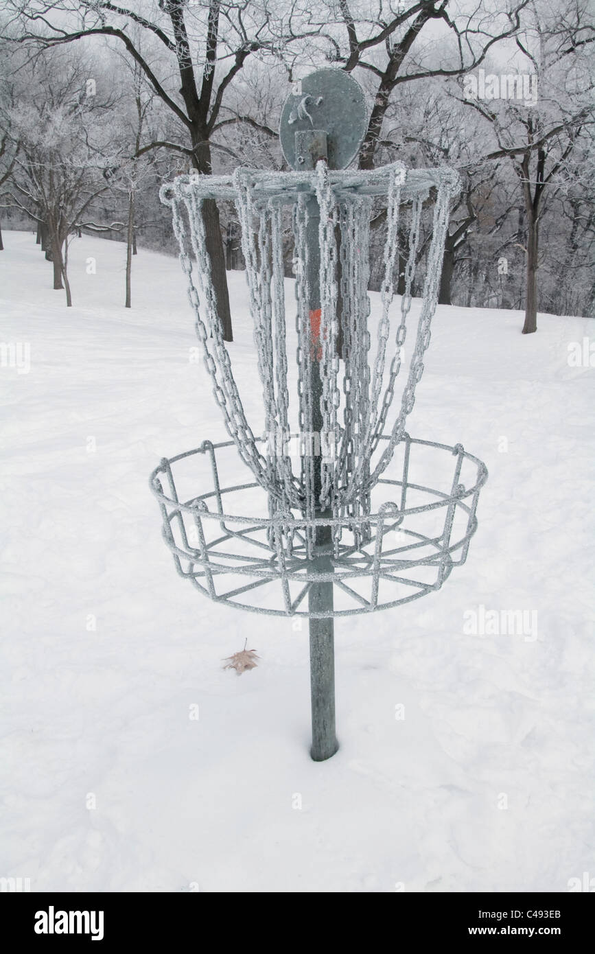 Disc golf scoring basket or pole hole on a snow covered course with