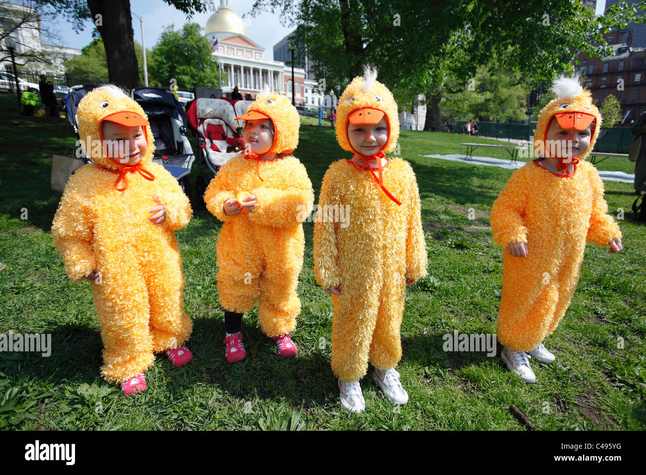 Children dressed in duck costumes, Duckling Day event by the State House on Boston Common, Boston, Massachusetts Stock Photo