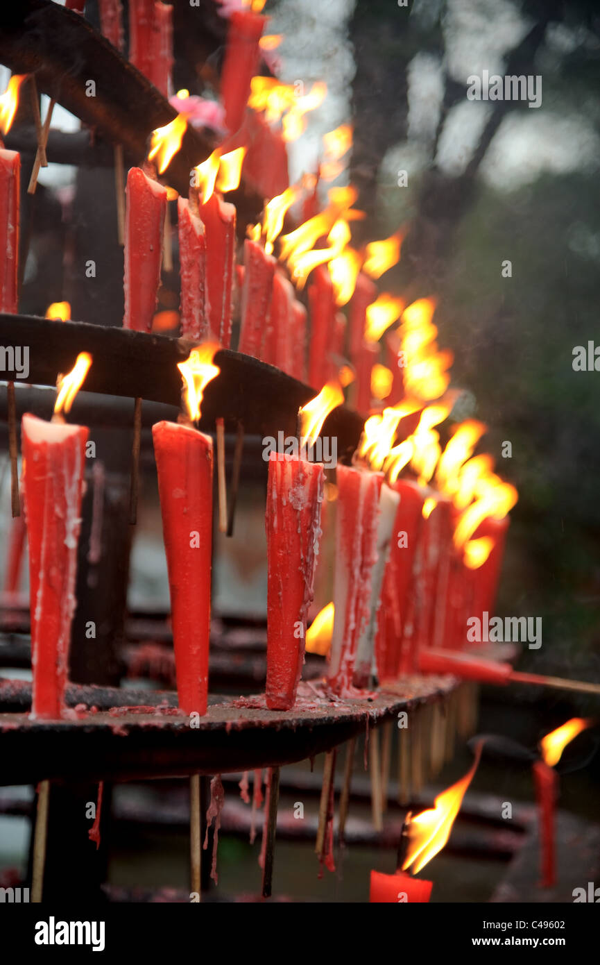 Burning red candles outside a temple Stock Photo Alamy