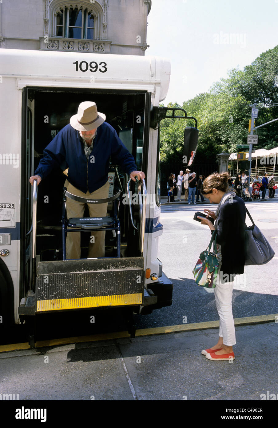 Elderly disabled man alone getting of New York City bus with an