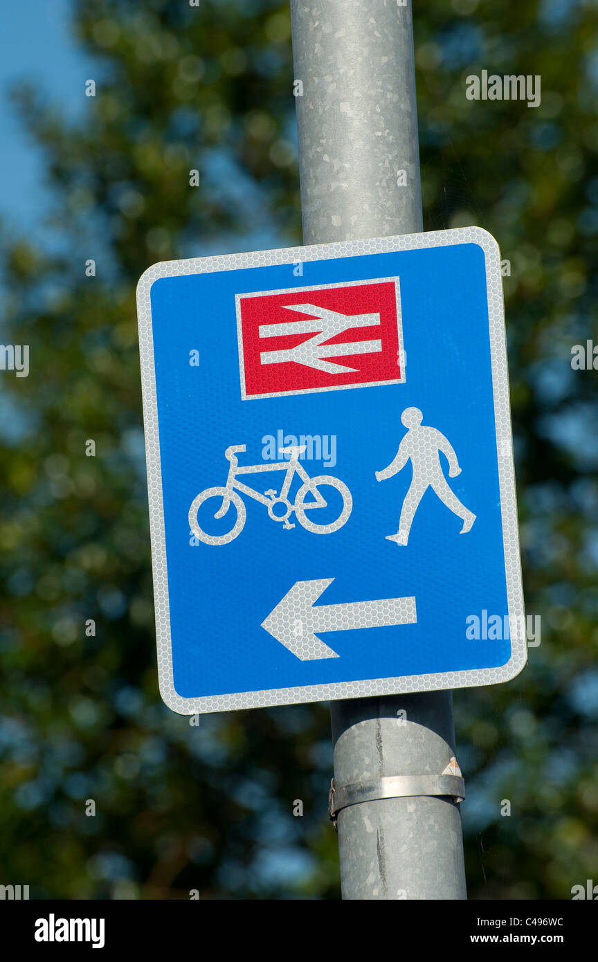 Sign showing pedestrian and cyclist access to a railway station in England. Stock Photo