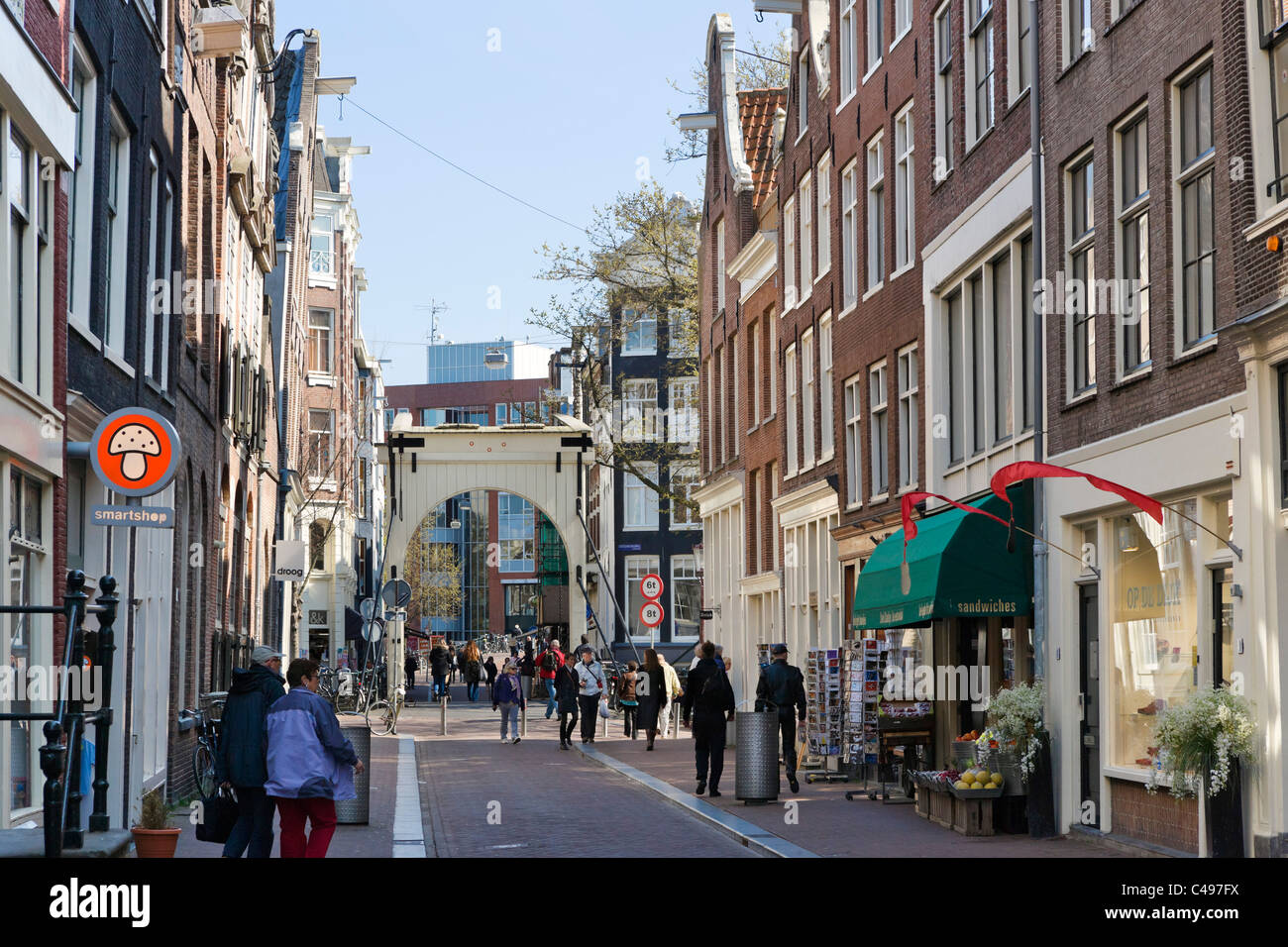 View down Staalstraat towards the bridge over the Groenburgwal canal in the city centre, Amsterdam, Netherlands Stock Photo