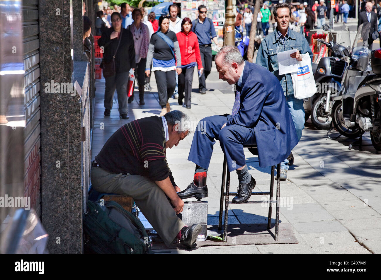 Street scene with shoeshine man, Buenos Aires, Argentina, South America. Stock Photo