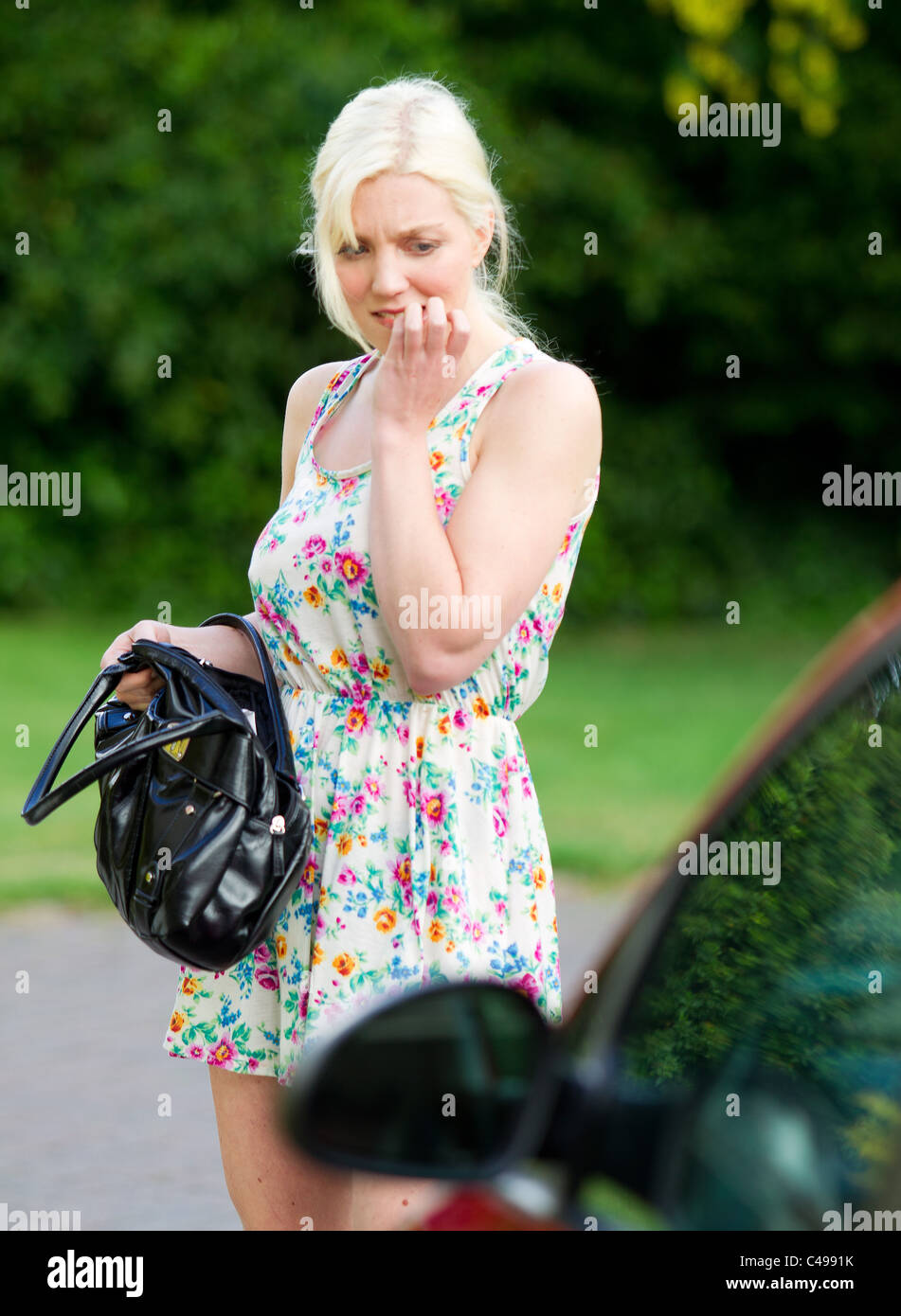 Woman looking for her lost keys Stock Photo