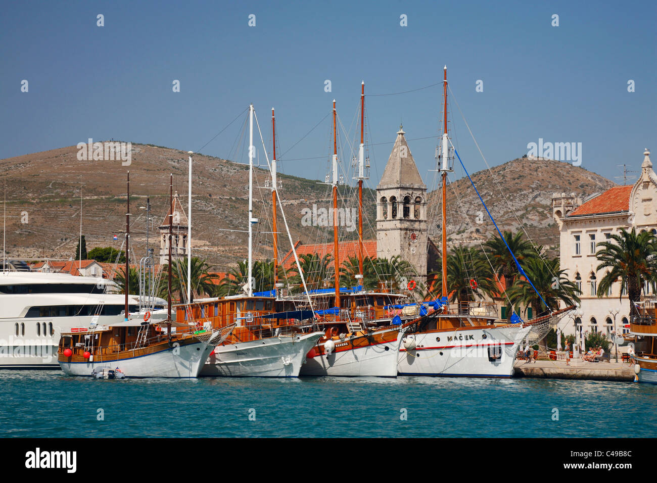 Cruise boats docking in harbor of Trogir town Stock Photo