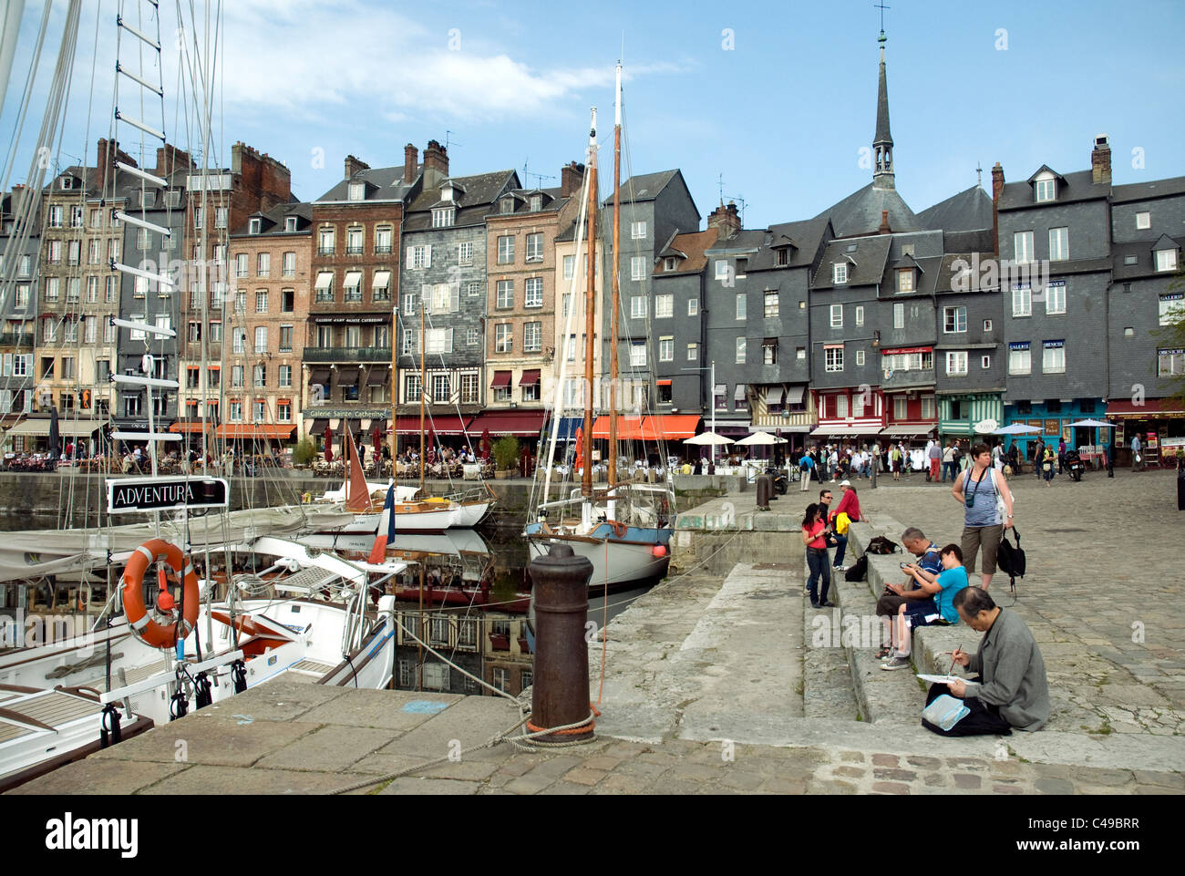 The broad quayside beside Honfleur's Vieux Bassin, old port, as in past times attracts artists and travellers Stock Photo