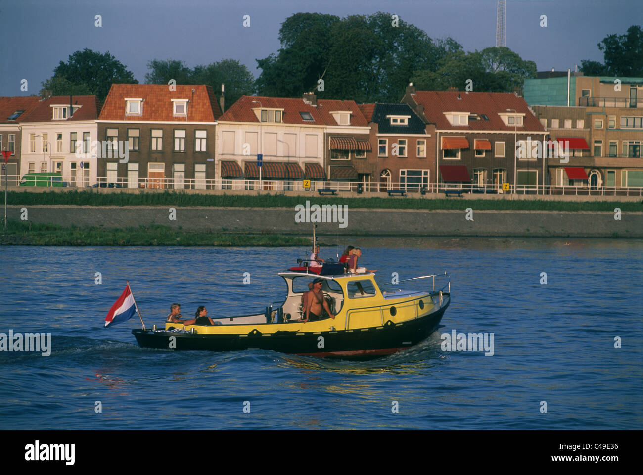 Photograph of a yello motor boat in a canal in Holland Stock Photo