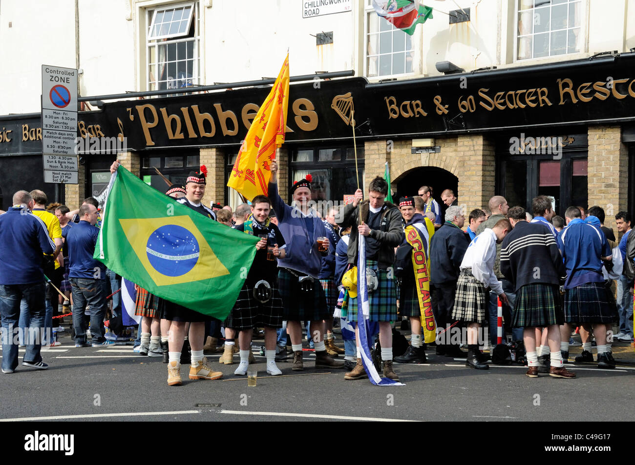 Scottish football supporters with flags outside Phibbers pub in Holloway London England UK Stock Photo