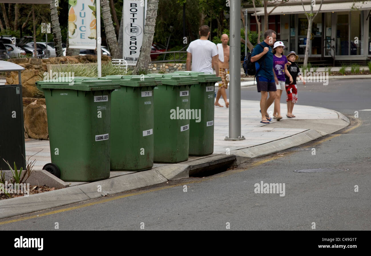 Green Recycling Bins at the side of the road awaiting collection Stock Photo