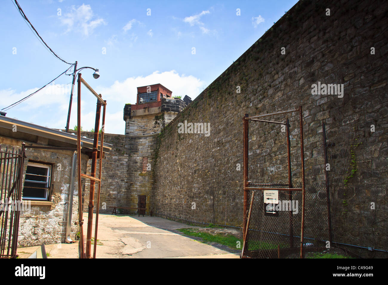 A guard tower and a high wall surround cellblocks at Eastern State Penitentiary. Stock Photo