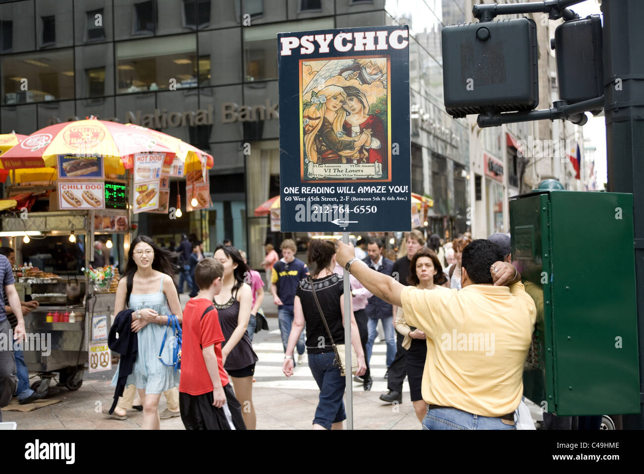 Psychic does street advertising along 5th Avenue in midtown Manhattan. In uncertain times fortune tellers flourish. Stock Photo