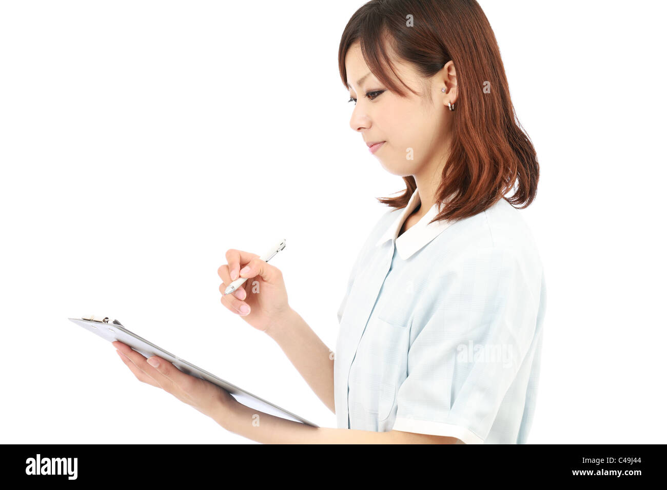 Young asian female nurse in uniform, holding a clipboard Stock Photo ...